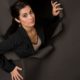 woman breaking out of hole in a brown wall