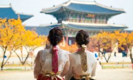 two women wearing traditional korean dress looking