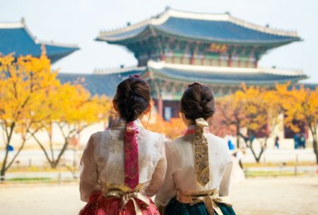 two women wearing traditional korean dress looking