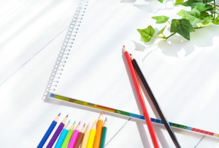 drawing book and colored pencils