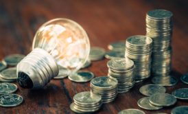 light bulb and stacks of silver coins