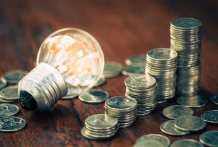 light bulb and stacks of silver coins