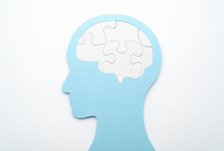 white jigsaw puzzle shaped like a human brain