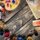 acrylic paints and palettes on wooden floor