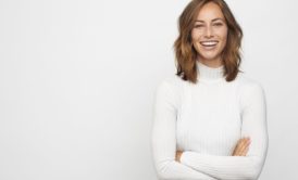 smiling and positive woman in white sweater