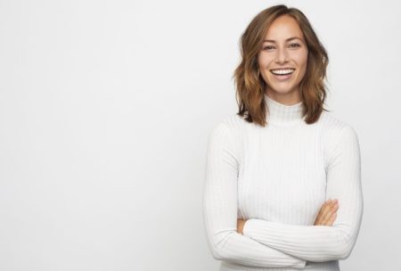 smiling and positive woman in white sweater
