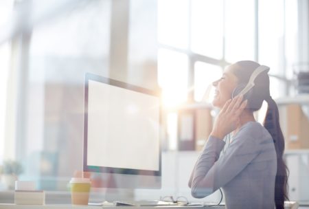 corporate music composer listening on white headphones