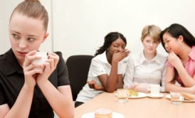 woman being bullied in the workplace by her female colleagues