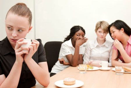 woman being bullied in the workplace by her female colleagues