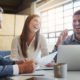 team of three professionals laughing and working together