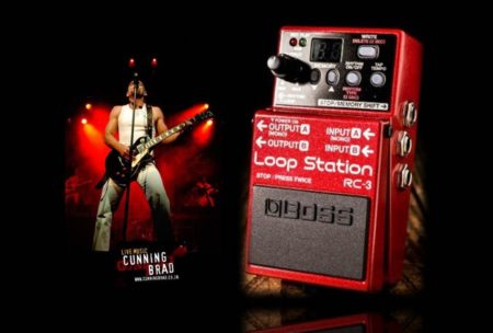 photo of man playing an electric guitar and a red live loop station