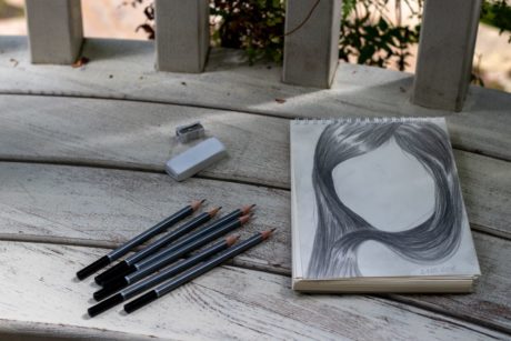 pencil portrait of a woman on a white sketchbook