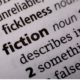 close up of the word fiction in the dictionary