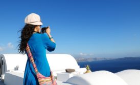 female travel taking a video of the ocean