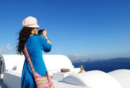 female travel taking a video of the ocean