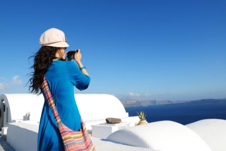 female travel taking a video of the ocean