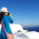 female travel taking a video of the ocean