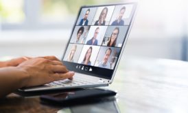 a person engaged in a video chat on a laptop, illustrating the concept of webinar marketing in action.