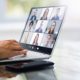 a person engaged in a video chat on a laptop, illustrating the concept of webinar marketing in action.