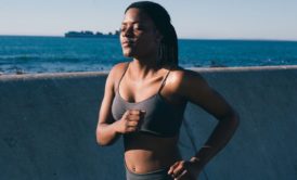 female runner in a green sports bra