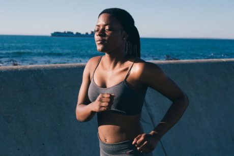 female runner in a green sports bra