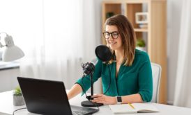 woman in green top recording a podcast