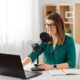 woman in green top recording a podcast