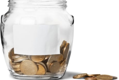 clear glass jar filled with bronze coins