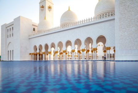 pool outside a white arabic temple