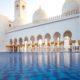 pool outside a white arabic temple