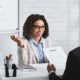 female applicant in white suit talking to a male interviewer