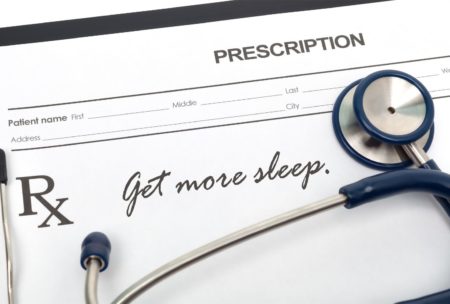 stethoscope and prescription with writing get more sleep