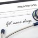 stethoscope and prescription with writing get more sleep