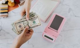 close up of female entrepreneur being paid with dollar bills