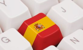 keyboard with a key that shows the spanish flag