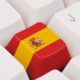 keyboard with a key that shows the spanish flag