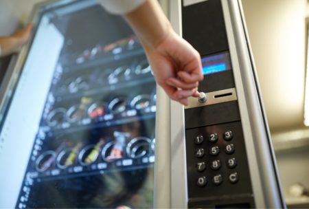 woman pressing buttons on a vending machine