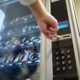 woman pressing buttons on a vending machine