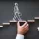 chalk drawing of a man walking on wooden chips