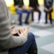 woman in brown sweater talking in group therapy