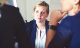 female applicant talking to two interviewers