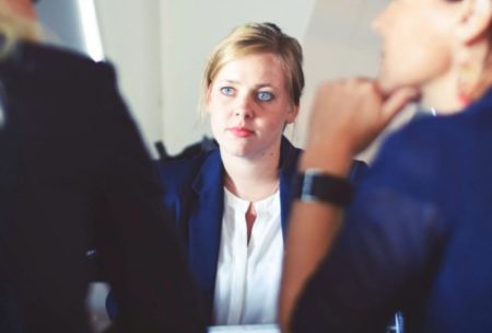 female applicant talking to two interviewers