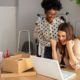 two happy women working on office desk