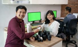 photo of smiling man and woman exchanging goods