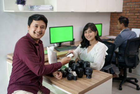 photo of smiling man and woman exchanging goods