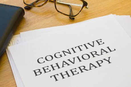 cognitive behavioral therapy printed on paper in all capital typeface