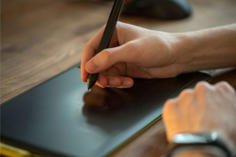 woman's hand drawing on a digital drawing tablet