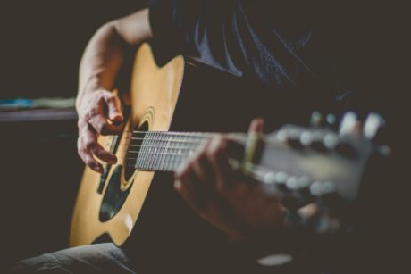 man playing an acoustic guitar