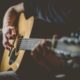 man playing an acoustic guitar