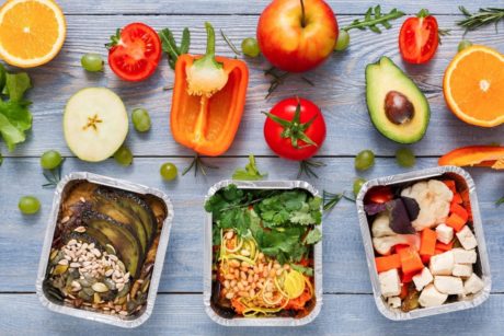 trays of healthy food arranged on top of gray wooden table